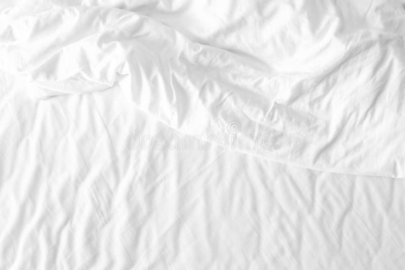Messy white bed sheets stock photo