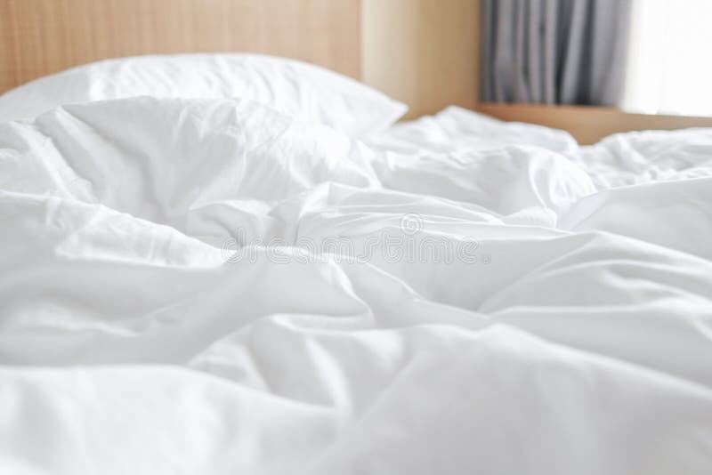 Messy white bed sheets stock image. Image of duvet, rippled - 128732731