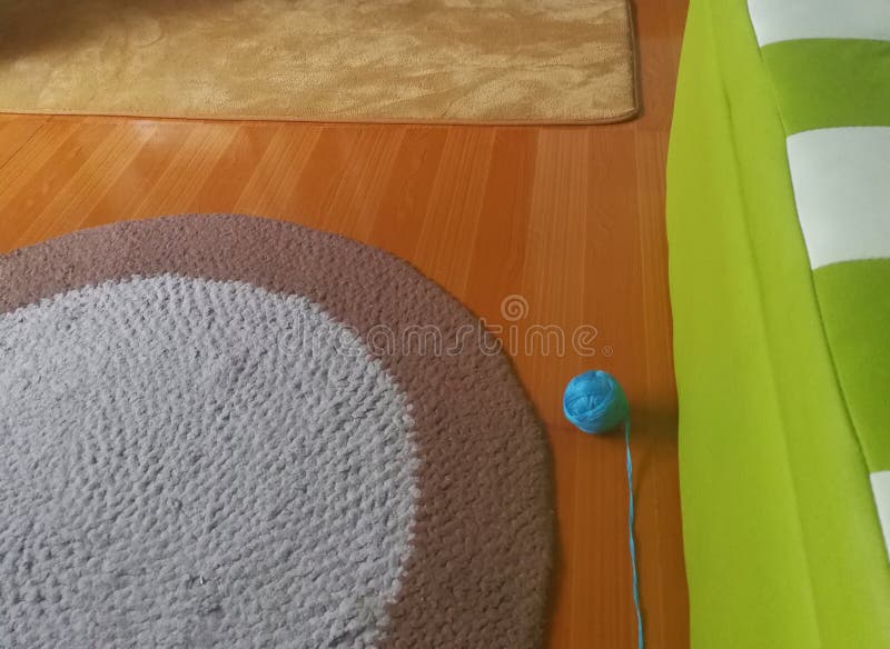Met de hand gemaakt tapijt, breiende bal op de vloer in de kleine ruimte stock foto's Met de hand gemaakt tapijt, breiende bal op de vloer in de kleine ruimte stock foto's
