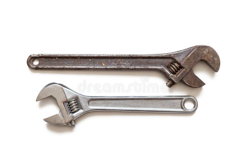 Metal adjustable wrenches, old and new, on white background