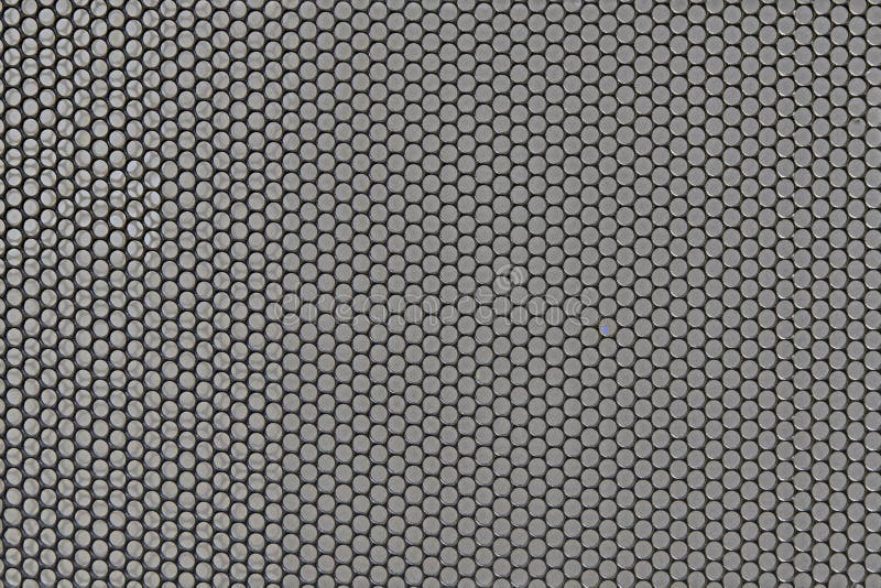 Metal background with round holes perforation, net of circles texture. Front view