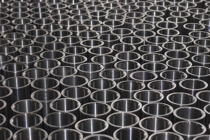 Photograph shows metal bushings of the same height, prepared for thermal processing. Photograph shows metal bushings of the same height, prepared for thermal processing