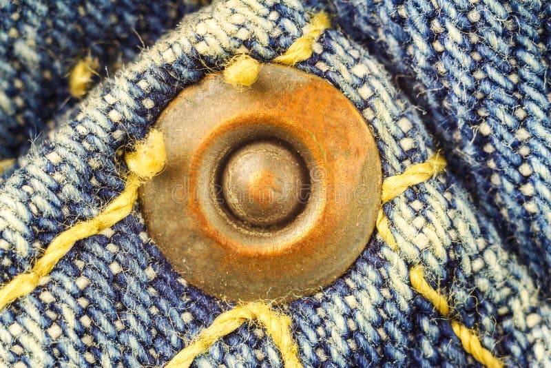 Metal Button on Blue Jeans, High Magnification Macro Image. Stock Photo