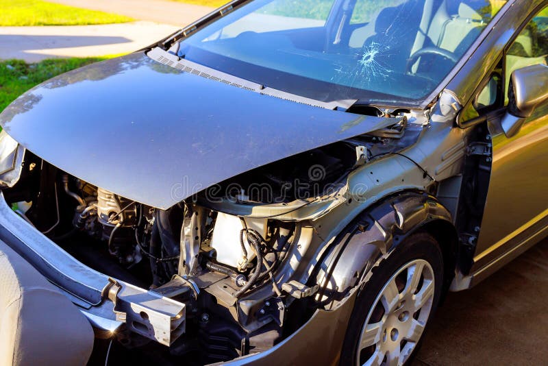 Car engine compartment exposed after collision repair work at residential driveway royalty free stock image