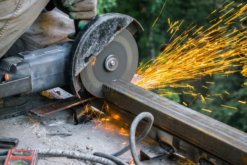 Metal Cutting Machine at Work. Worker Cutting Metal with Grinder Stock