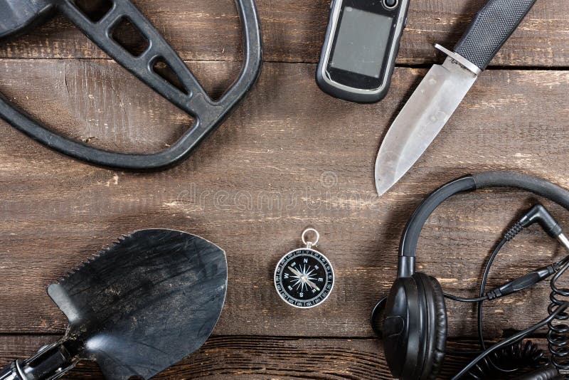 Metal detector accessories placed on old rustic wooden table. stock images Metal detector accessories placed on old rustic wooden table. stock images