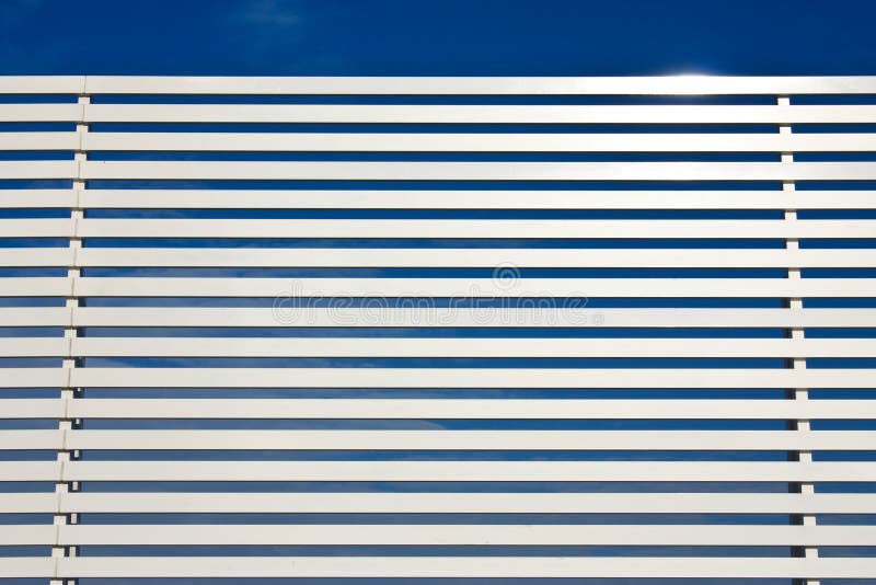 Metal fence lines and blue sky