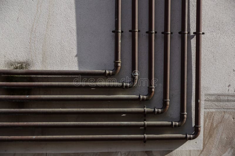 Metal gas pipe on in cement urban wall stock images