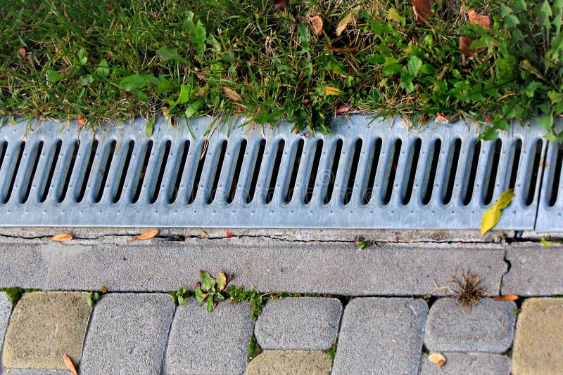 Metal grate of rainwater drainage system in a park