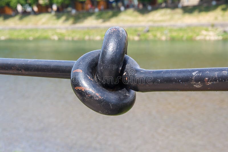 Metal handrail folded in a knot closeup stock image