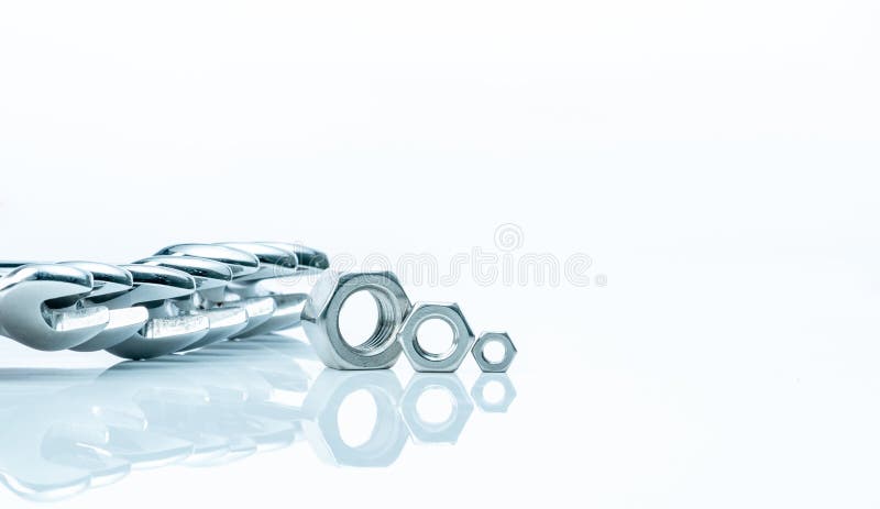 Metal hexagon nuts and chrome wrenches on white background. Mechanic tools for maintenance. Hardware tool. Fastener with stock photos Metal hexagon nuts and chrome wrenches on white background. Mechanic tools for maintenance. Hardware tool. Fastener with stock photos