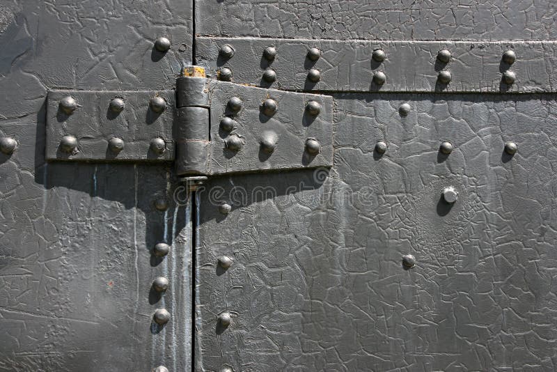 Industrial steel tin door texture. Metal hinge and bolts.