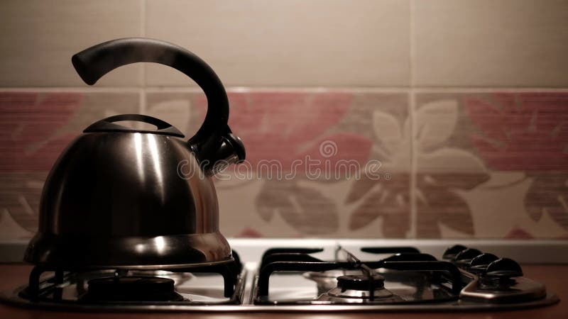 Tea kettle with boiling water on gas stove Stock Photo by ©Kruchenkova  58951339