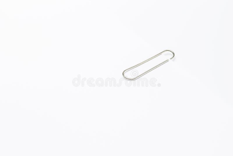 Metal Paper Clip and Paper Isolated on White Background. Stock Photo