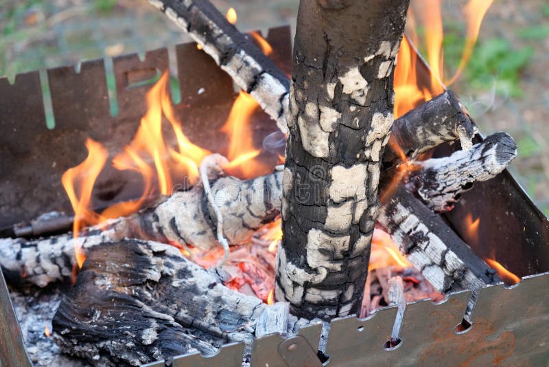 Metal portable barbecue on the ground in the yard. royalty free stock photo Metal portable barbecue on the ground in the yard. royalty free stock photo