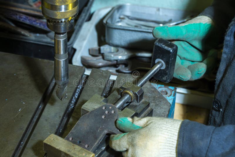 Metal Processing Concepts. Professional Fitter Man Using Metal Drilling