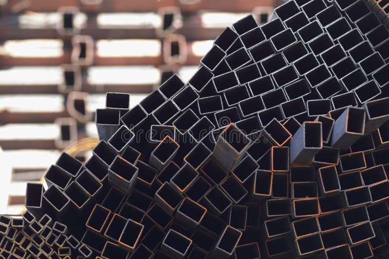 Metal profile pipe of rectangular cross section in packs at the warehouse of metal products royalty free stock photo