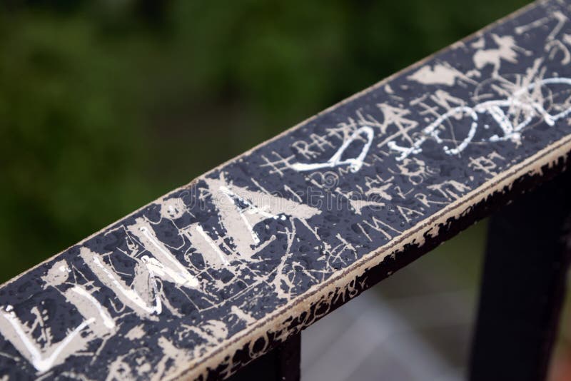 Metal Railing with Patterns Scratched into the Paint and Engraved with