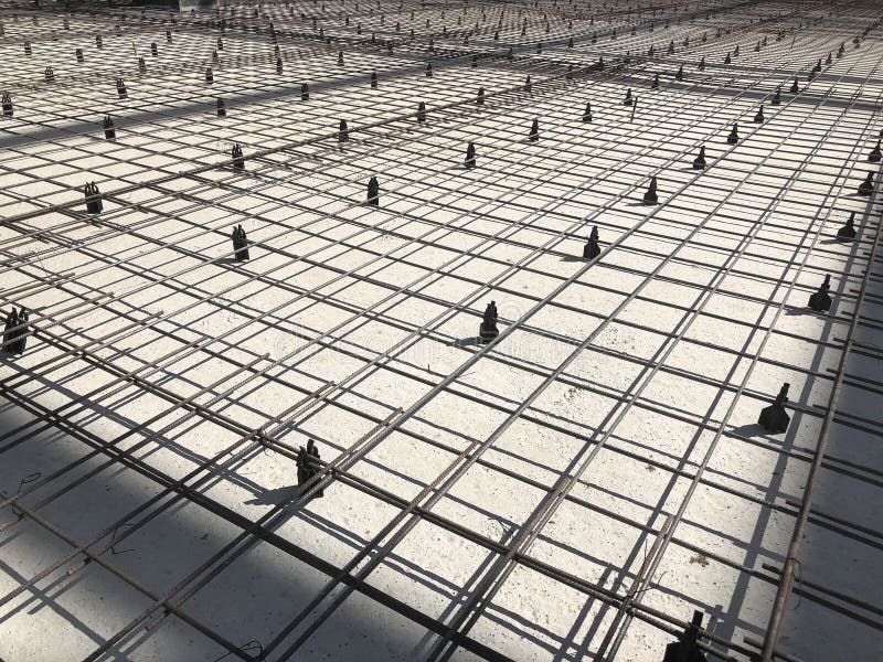 Metal reinforcement grid with plastic holders. Reinforced concrete preparation. Concrete basement construction