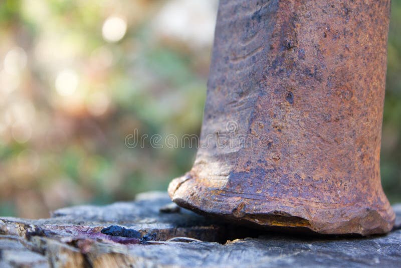 Metal rusty hammer on a wooden