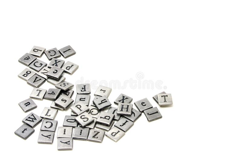 Metal scrapbooking letters laying on a white background.