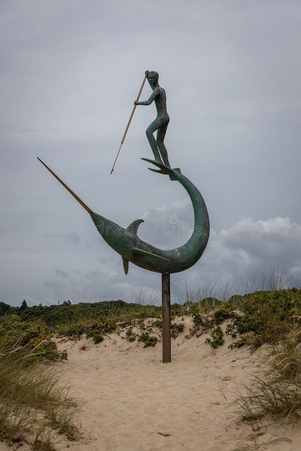 Metal Sculpture of a Harpooner on the Beach Editorial Photography