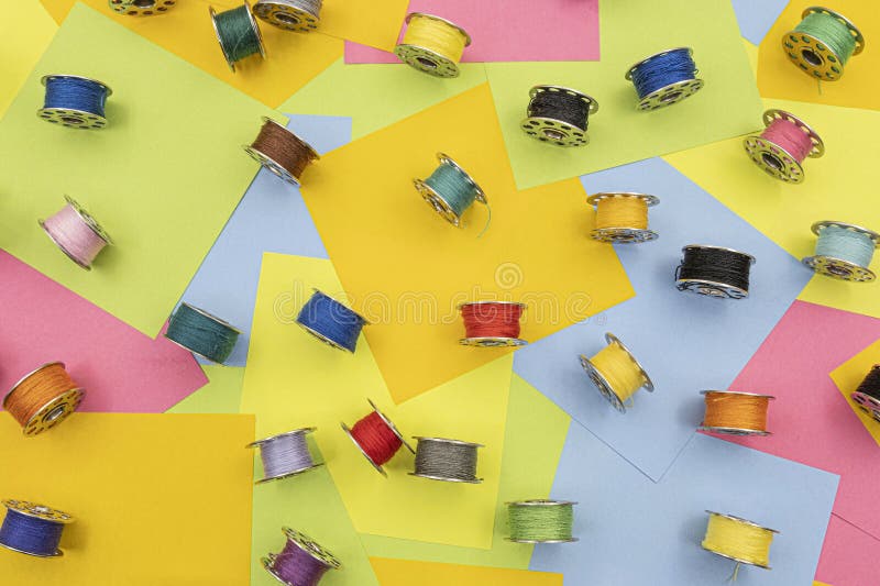 Metal Spools with Multicolored Thread for Sewing Machine on a Table
