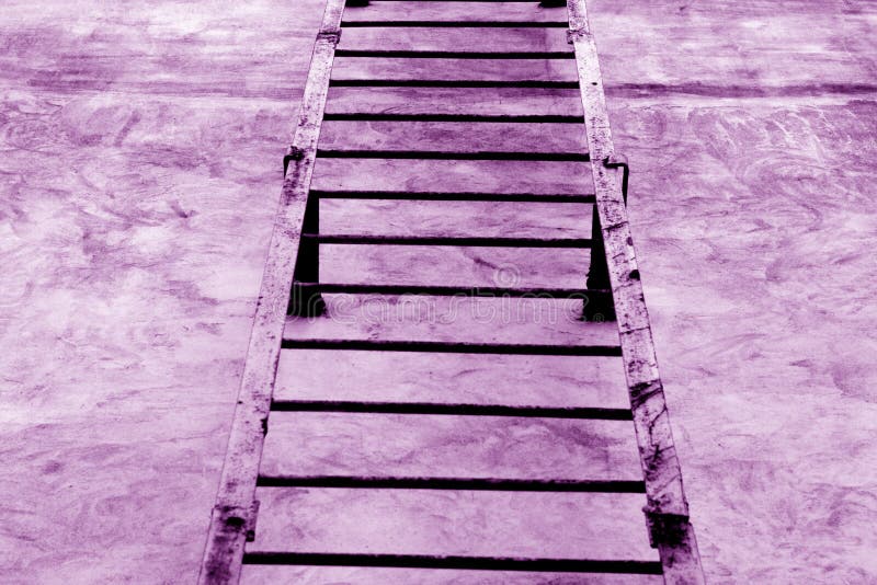 Metal stairway on cement wall in purple tone. stock photo Metal stairway on cement wall in purple tone. stock photo
