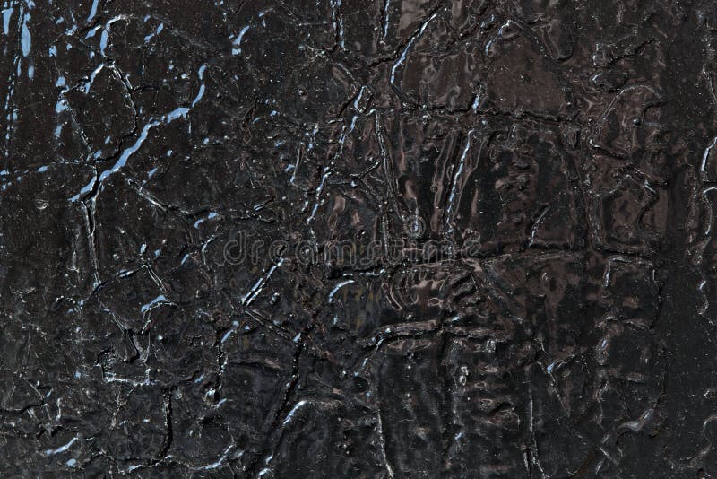 The metal surface is painted with black oil paint. stock photos The metal surface is painted with black oil paint. stock photos