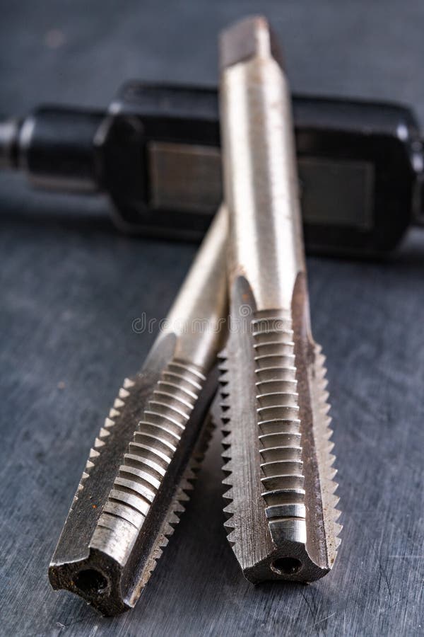 Metal thread cutting tools. Tool steel accessories for locksmiths stock photos