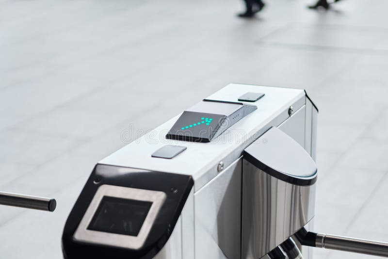 Metal turnstile with forward arrow to signal passage permitted stock image