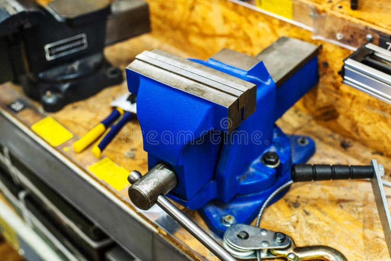 Metal Vise on a Workbench. Equipment for Fixing Parts during Processing