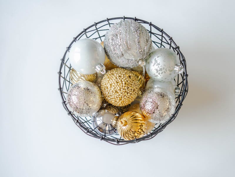 A metal wicker basket with various gold and silver Christmas balls. Selective focus royalty free stock images A metal wicker basket with various gold and silver Christmas balls. Selective focus royalty free stock images