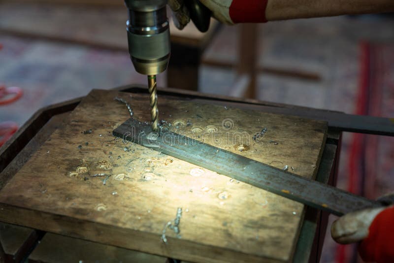 Metal Worker Drilling Holes in Metal with a Bench Drill Stock Image