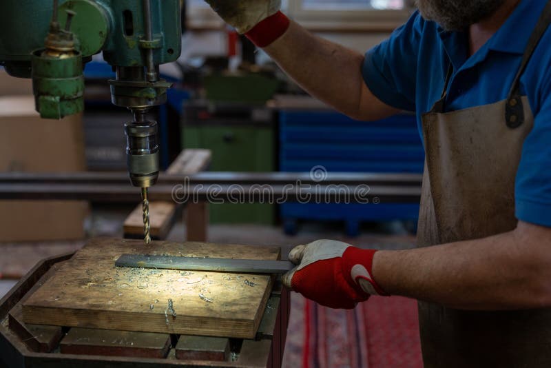 Metal Worker Drilling Holes in Metal with a Bench Drill Stock Image