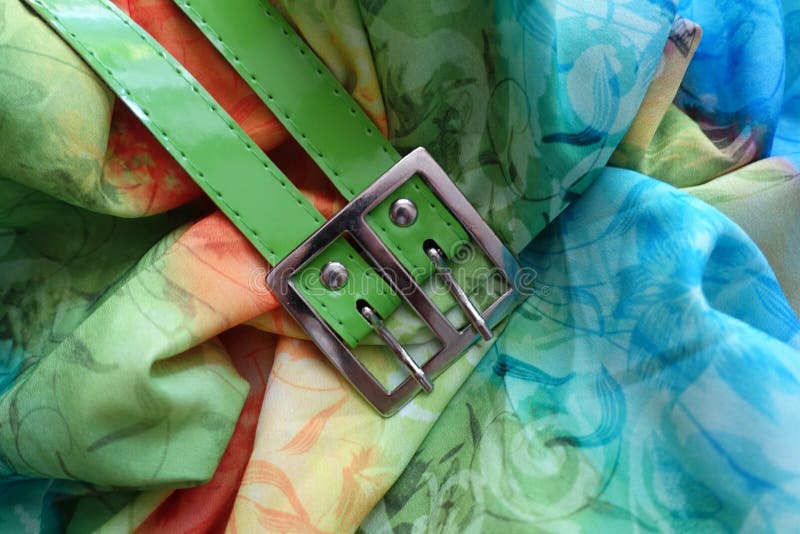 Metallic buckle and green belt on rayon royalty free stock image Metallic buckle and green belt on rayon royalty free stock image