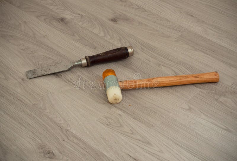 A metallic chisel with wooden handle and special hammer on the laminate background royalty free stock photos A metallic chisel with wooden handle and special hammer on the laminate background royalty free stock photos