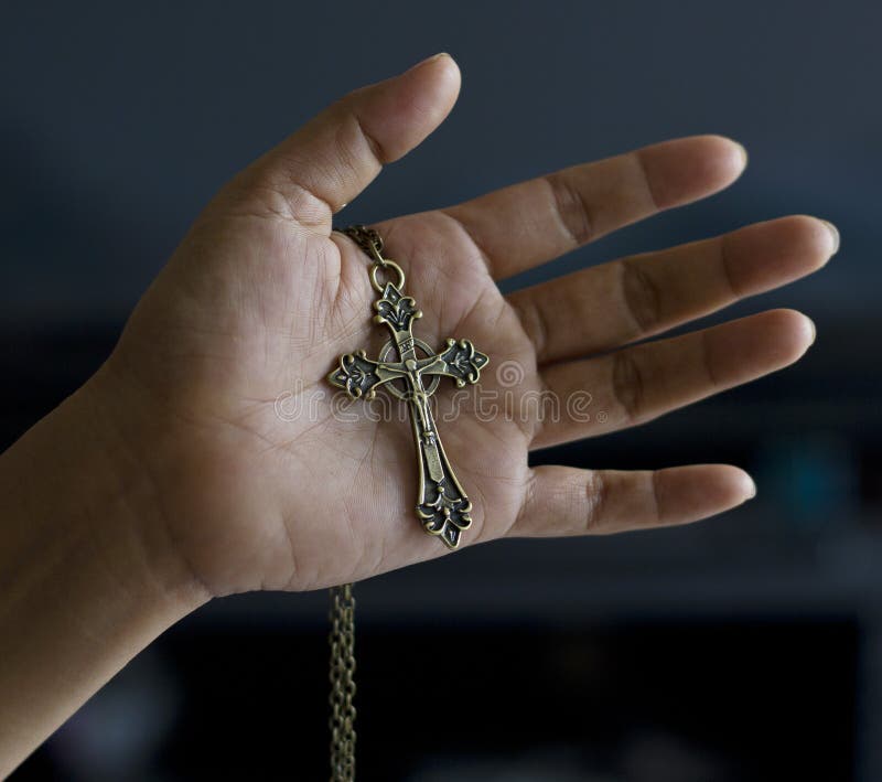 Metallic crucifix in hand