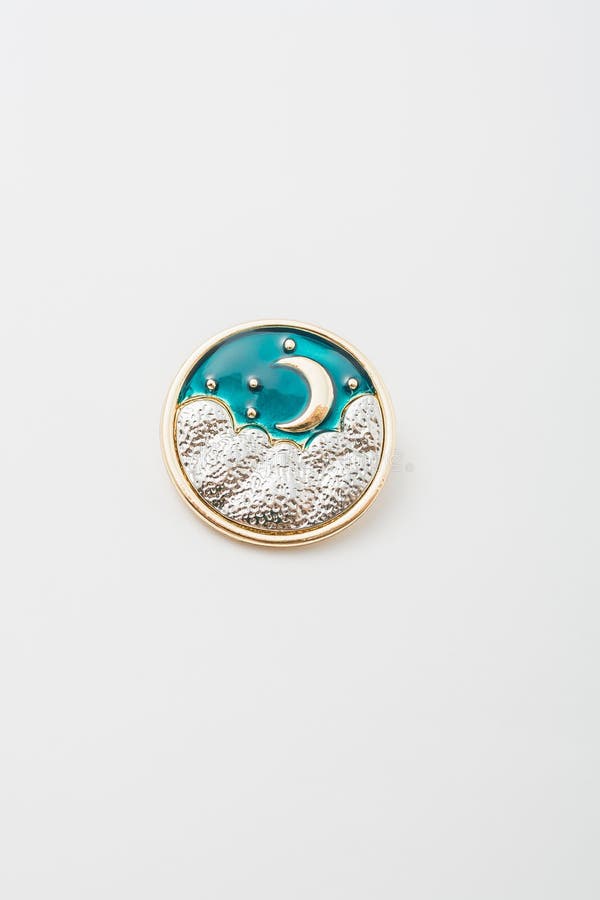 Metallic golden round brooch with sky, stars and moon. Spiritual esoteric symbol, astrological boho sign, pin on white. bijouterie, jewelry
