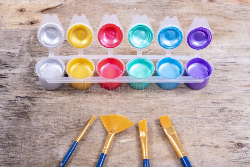 Metallic Paint Pots and Set of Brushes for Decorations Stock Photo