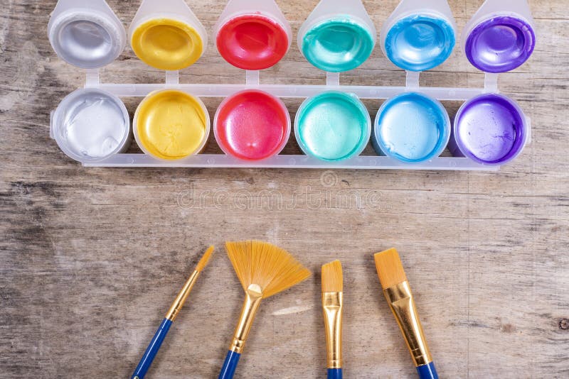 Metallic Paint Pots and Set of Brushes for Decorations Stock Photo
