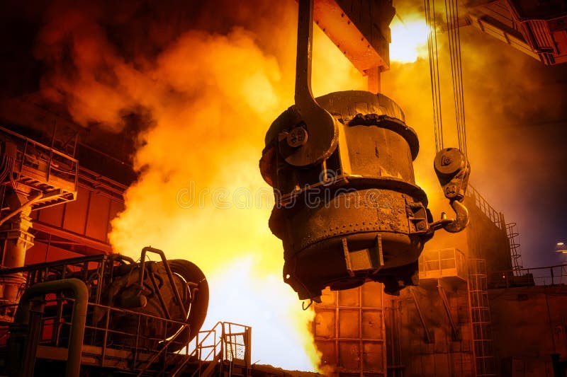 A metallurgical ladle filled with molten metal bucket is suspended on a special crane beam