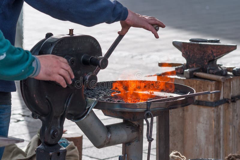 Metalsmith Blowing Air on the Fire Editorial Photography Image of