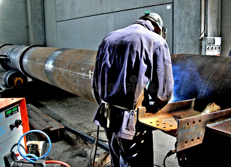 Metalwork Construction of Large Tubes with Workers Working Welding