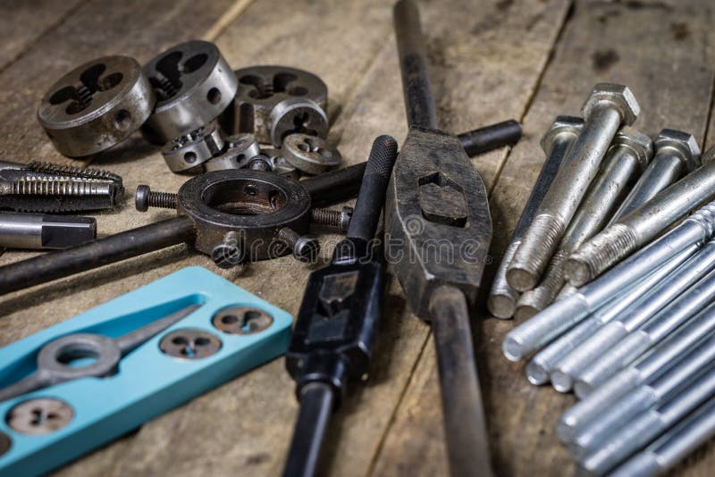 Metalwork tools on the workshop table. Threading dies and taps i royalty free stock photos