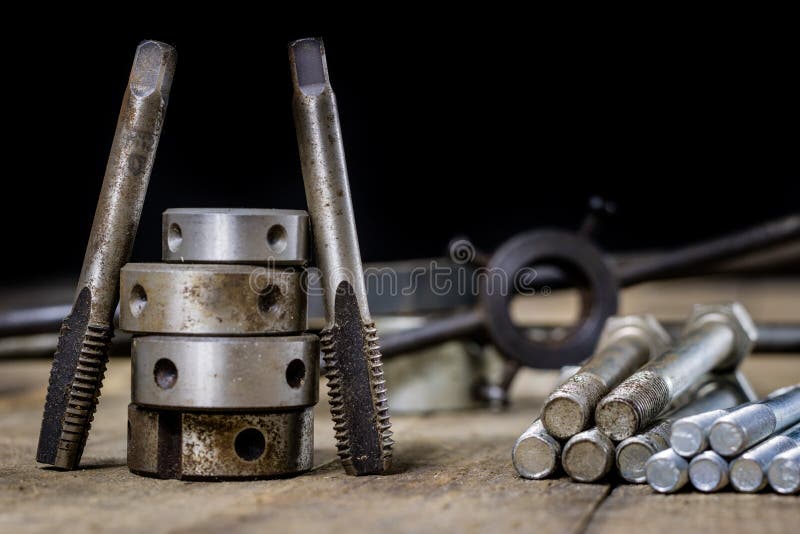 Metalwork tools on the workshop table. Threading dies and taps i royalty free stock photo