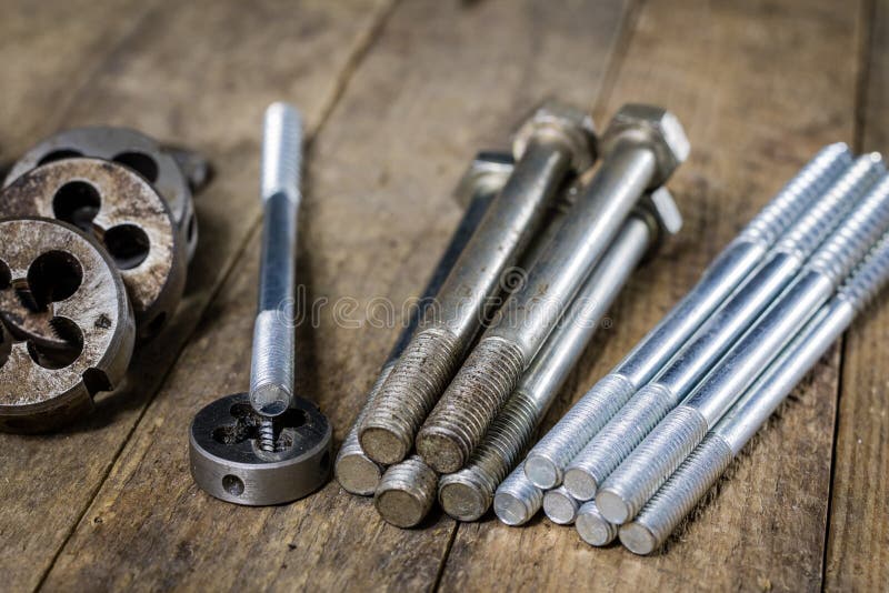 Metalwork tools on the workshop table. Threading dies and taps i stock photo