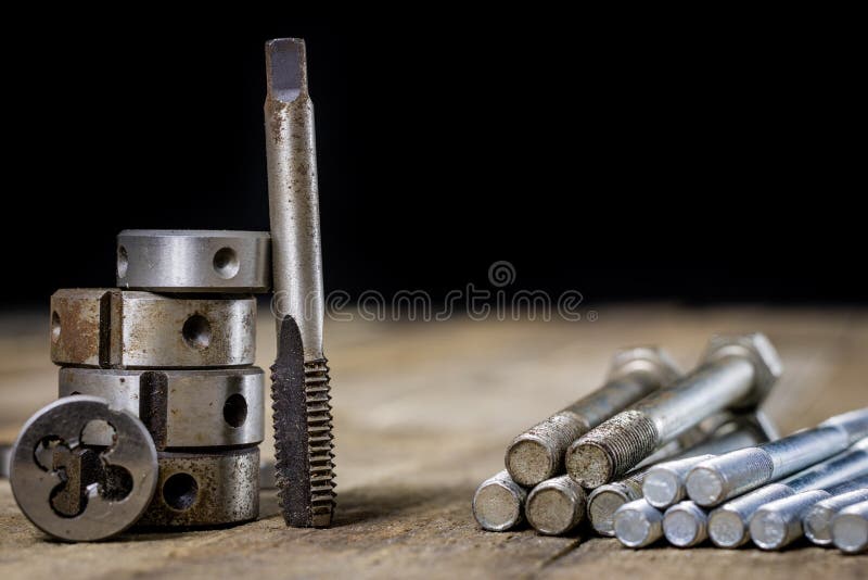 Metalwork tools on the workshop table. Threading dies and taps i royalty free stock photography