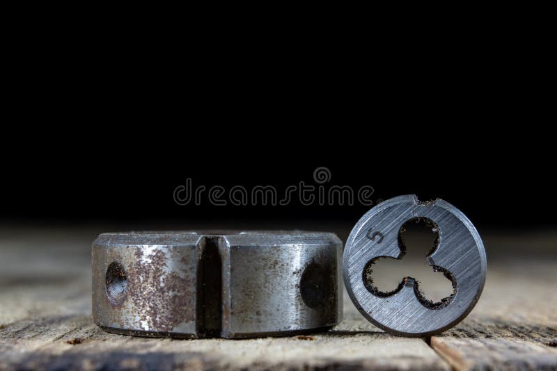 Metalwork tools on the workshop table. Threading dies and taps i royalty free stock images