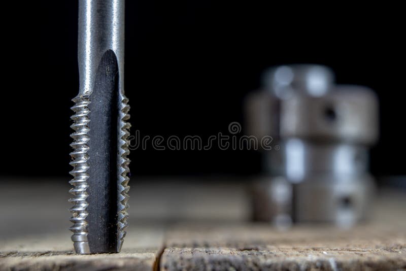 Metalwork tools on the workshop table. Threading dies and taps i royalty free stock images